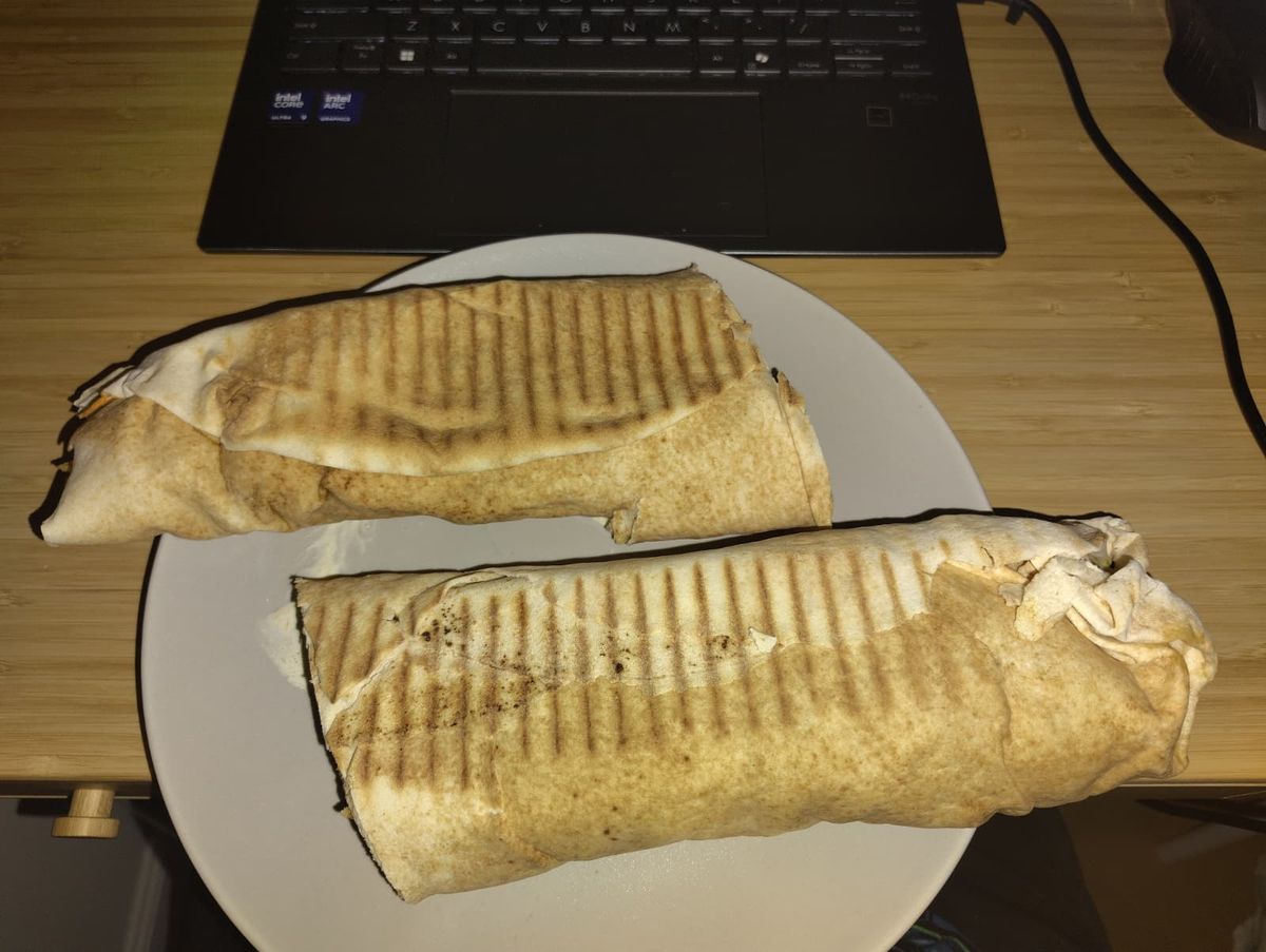 A large kebab with yufka bread cut in the middle
