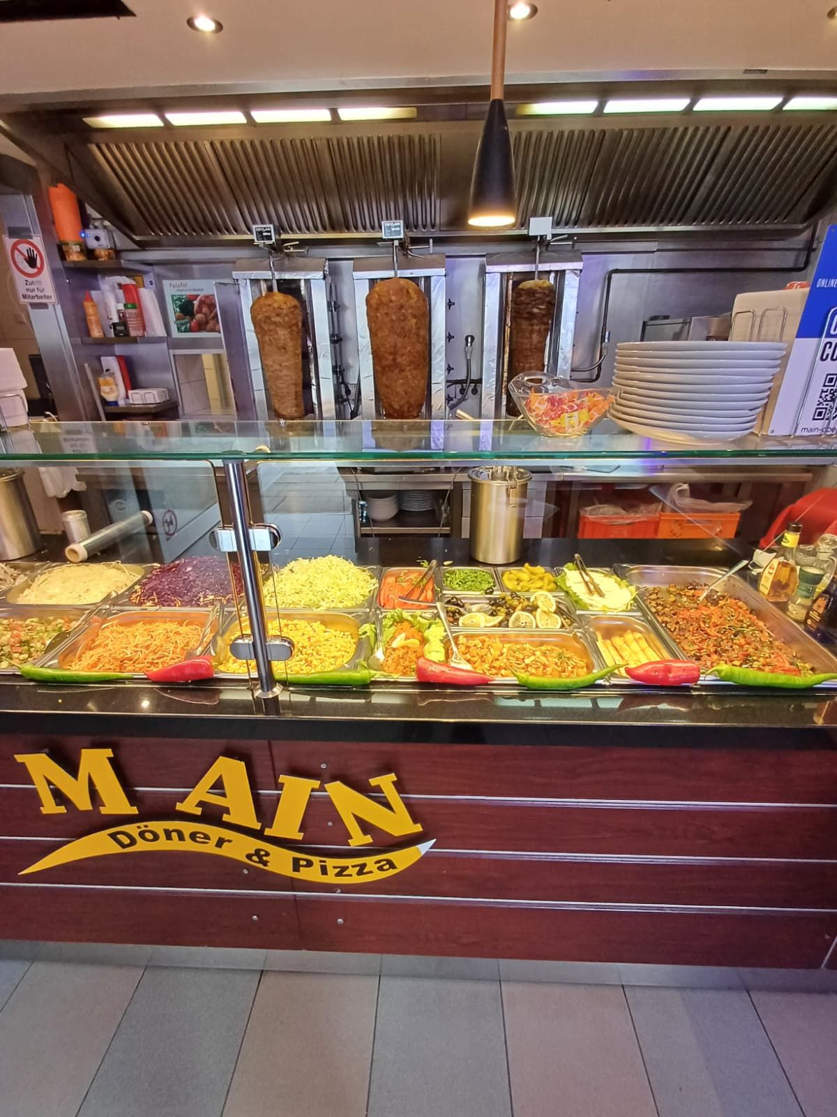 Main doner and kebab food counter showing rotating kebabs and additional ingredients