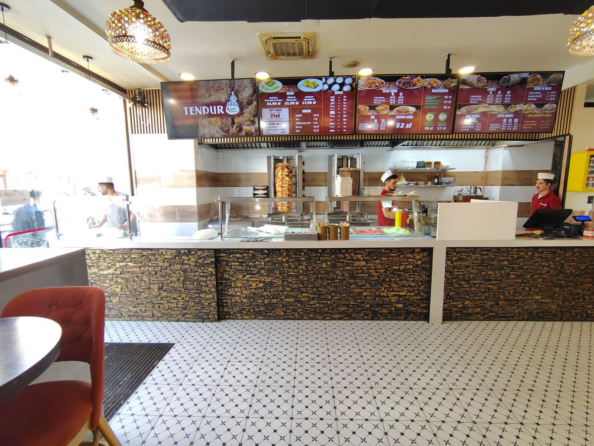 Inside of Tendur Kebap shop showing menu and workers