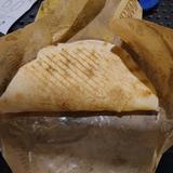 A semi-circle whole kebab pre-feast sitting on a metal table