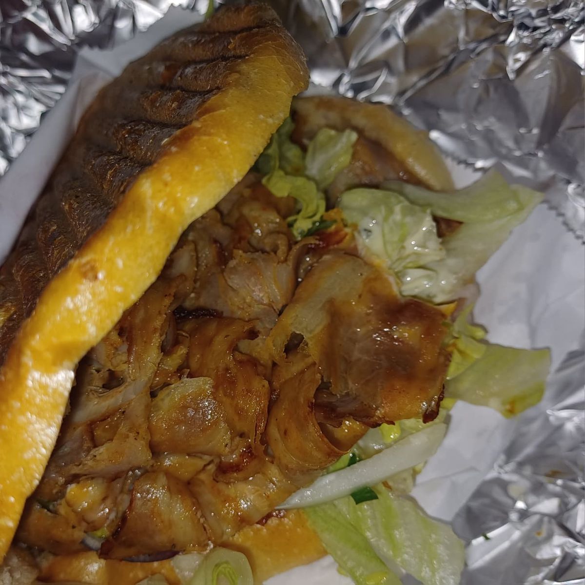 A chicken kebab on pita bread