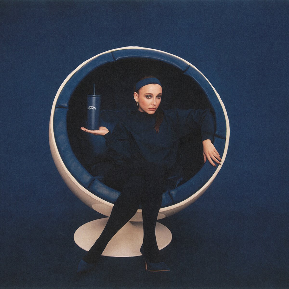 Emma Chamberlain seated in a studio portrait