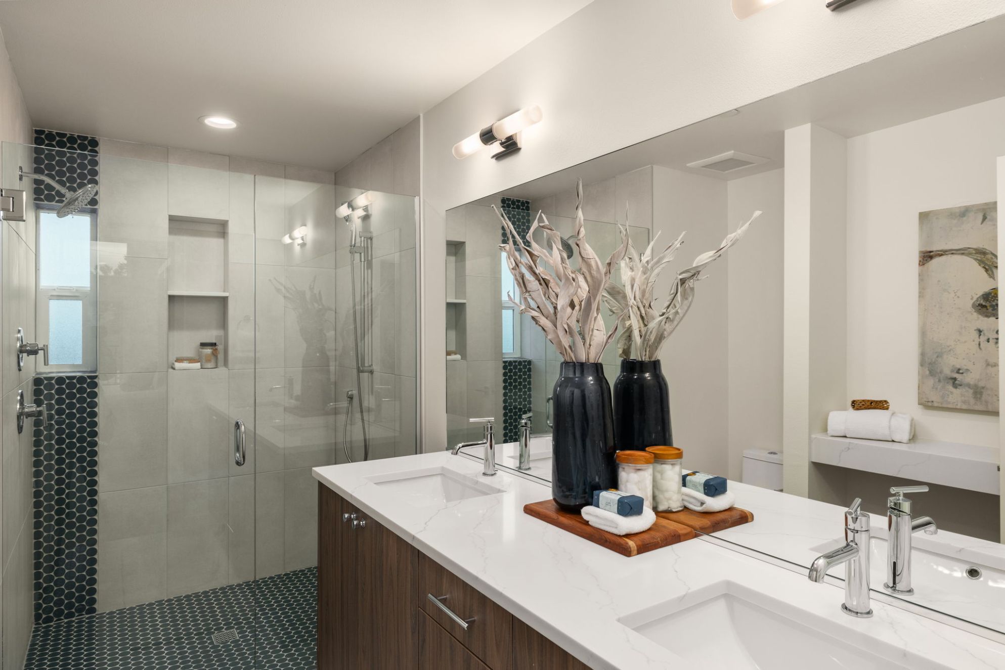 Bath with a quartz-topped double vanity and walk-in shower