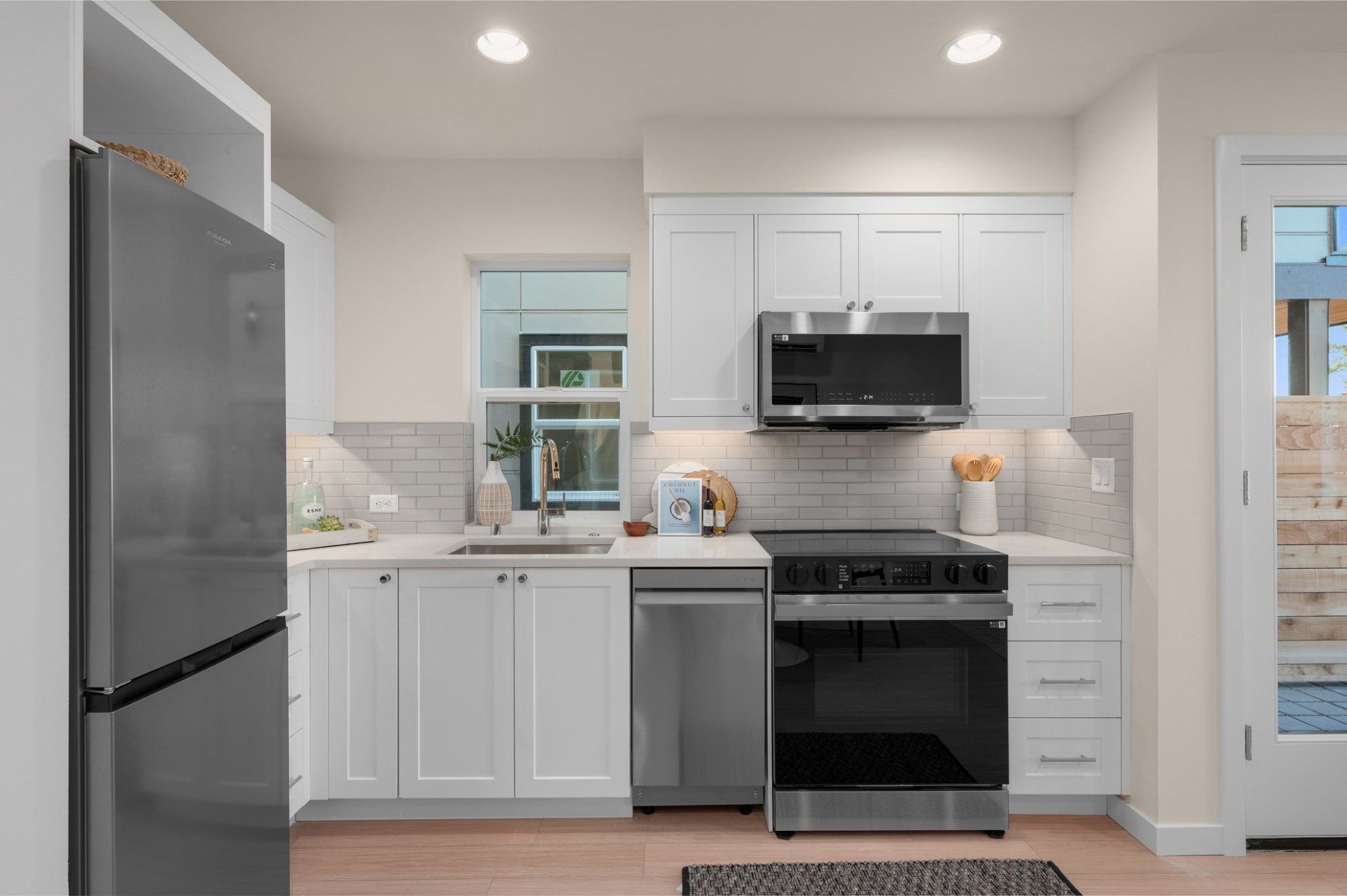 The two-bedroom home's kitchen, white cabinetry and stainless appliances