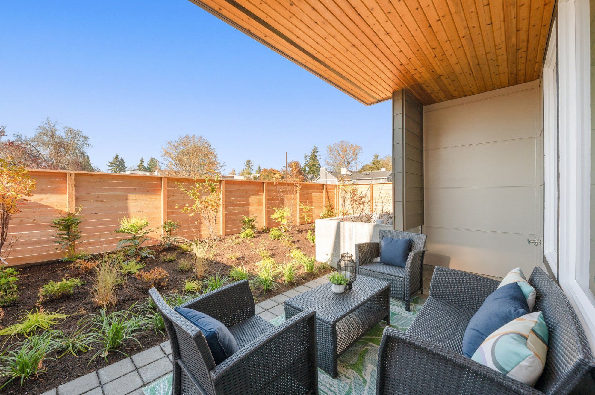 A cedar-lined covered patio with the courtyard planting beyond