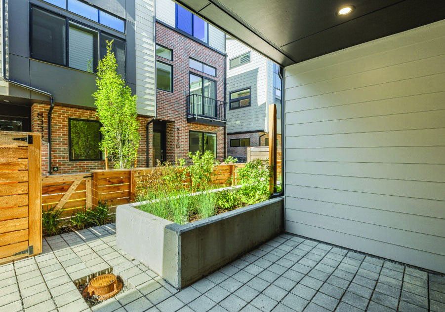 A Shelter Homes courtyard: brick, cedar, and planted raised beds