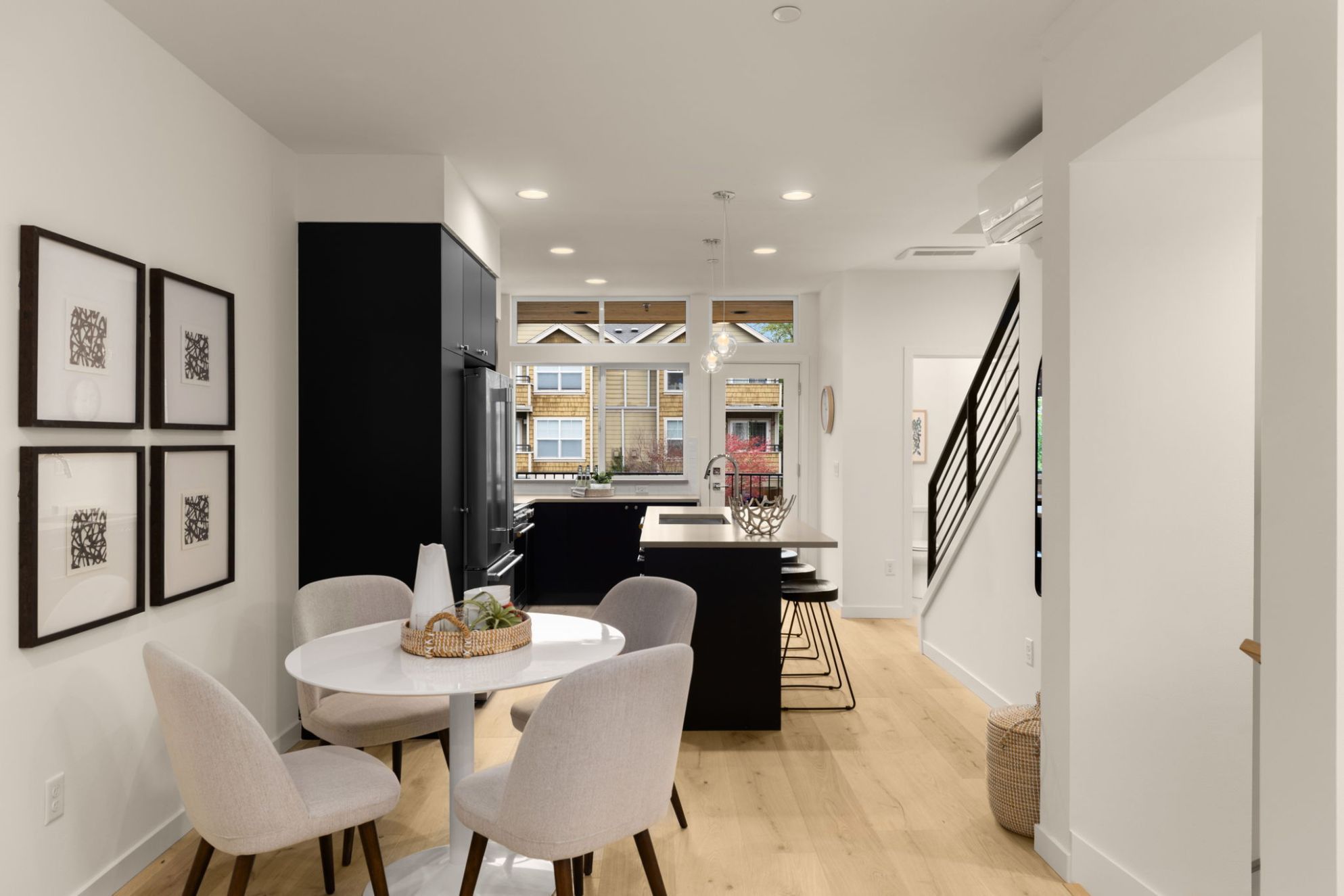Kitchen and dining opening to the street-level windows