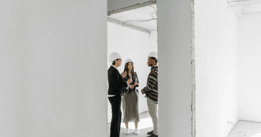 Group discussing potential property purchase inside an unfinished building.