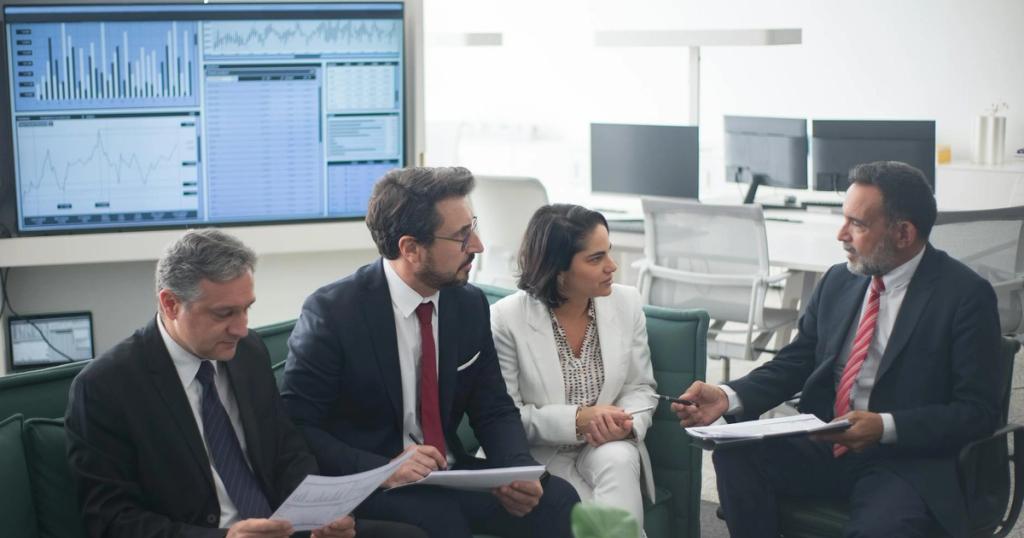 Group of business professionals discussing financial strategies in a modern office setting.