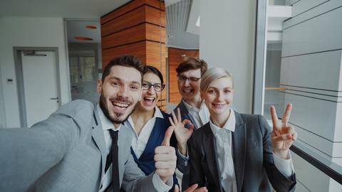 Group of happy business people taking a selfie