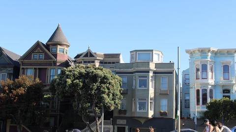 a group of people sitting on the grass in front of a building