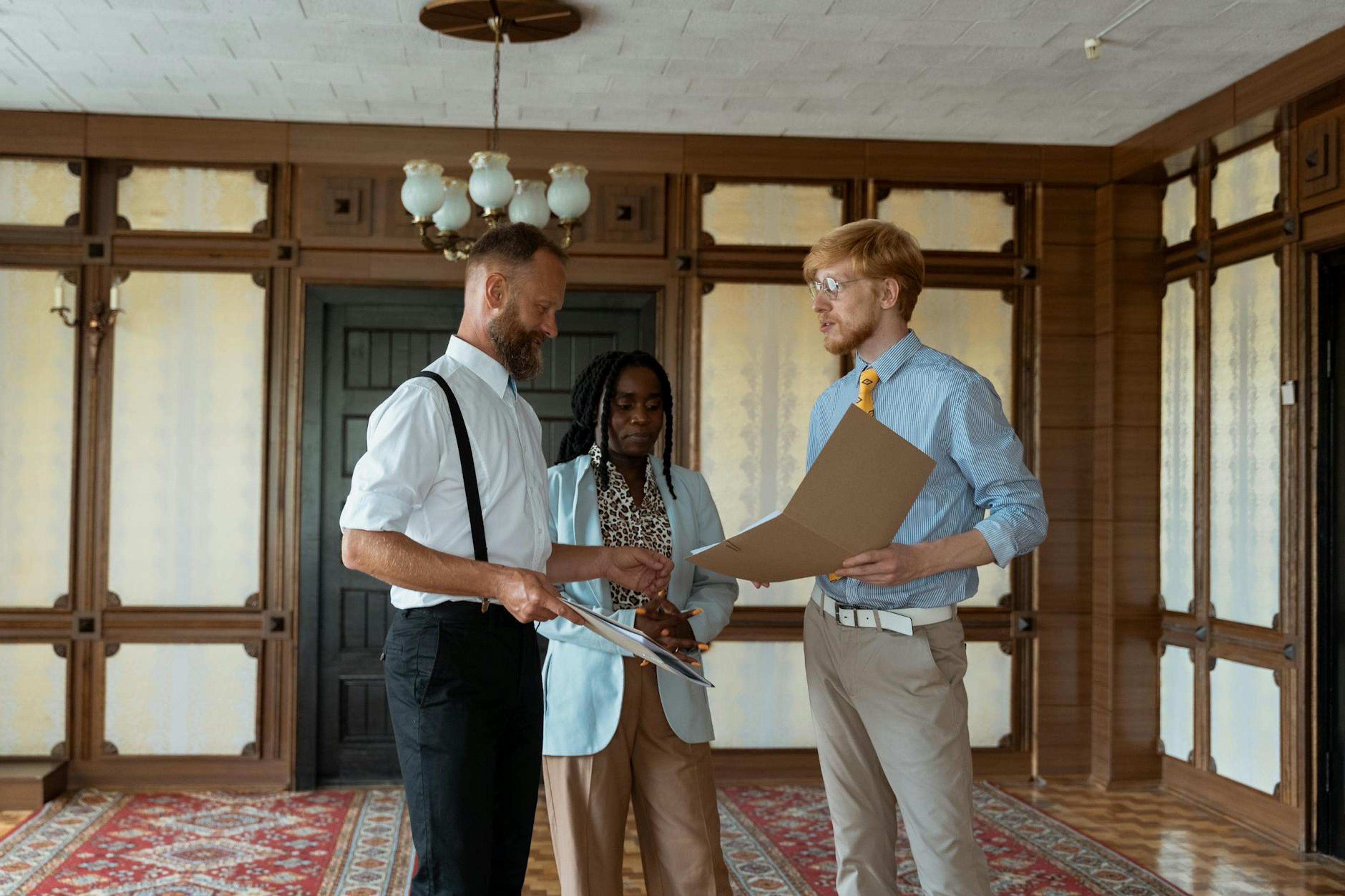 Three business professionals engaged in a discussion in a vintage office setting, showcasing teamwork and collaboration.