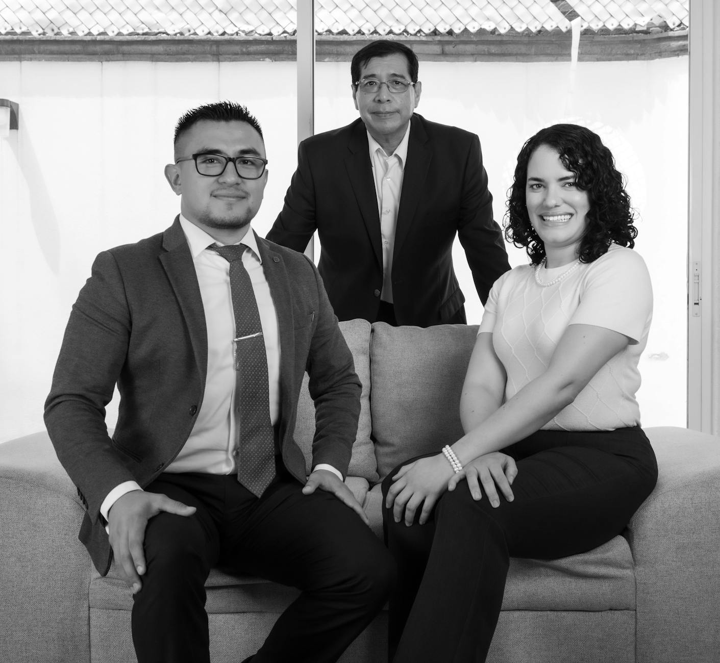 Elegant group business portrait featuring a professional team in suits, captured indoors.