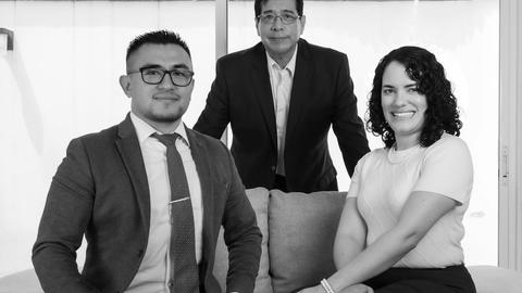 Elegant group business portrait featuring a professional team in suits, captured indoors.