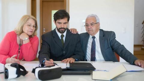 Senior couple in a meeting with a real estate agent discussing property details.