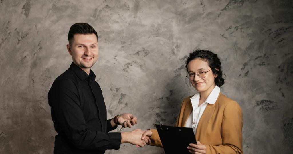 Man and woman shaking hands in a business agreement indoors, smiling confidently.
