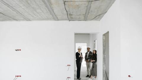 Group of diverse professionals discussing building plans on site.