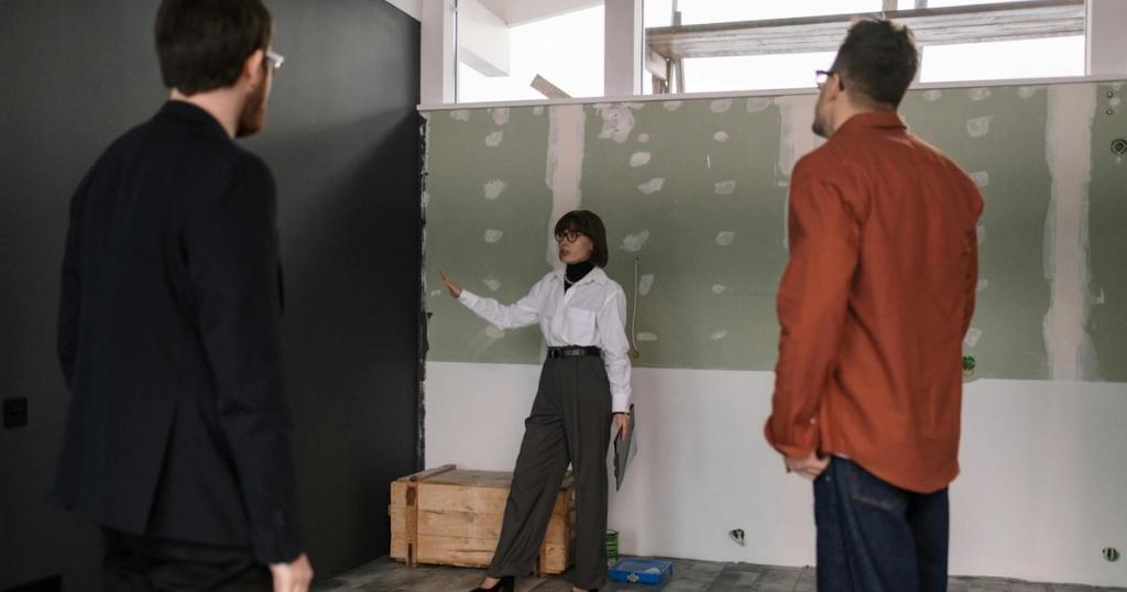 A group of professionals discussing a renovation project inside a building.