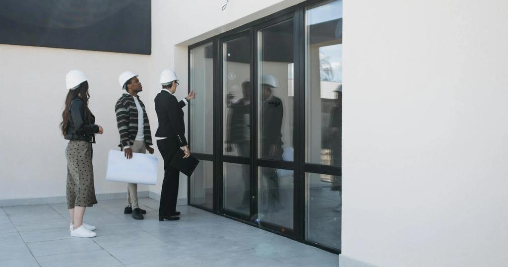 A diverse group of architects and a real estate agent examine a modern building, focusing on large glass windows.