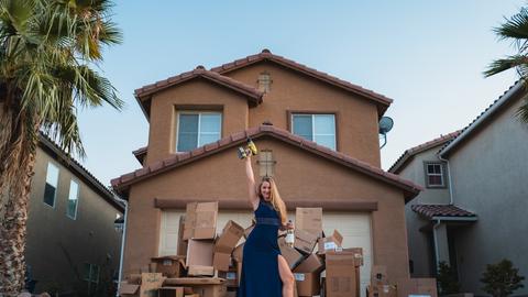 woman in black dress standing near brown concrete building during daytime