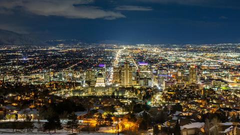 A breathtaking aerial view of Salt Lake City at night featuring a vibrant skyline and illuminated buildings.