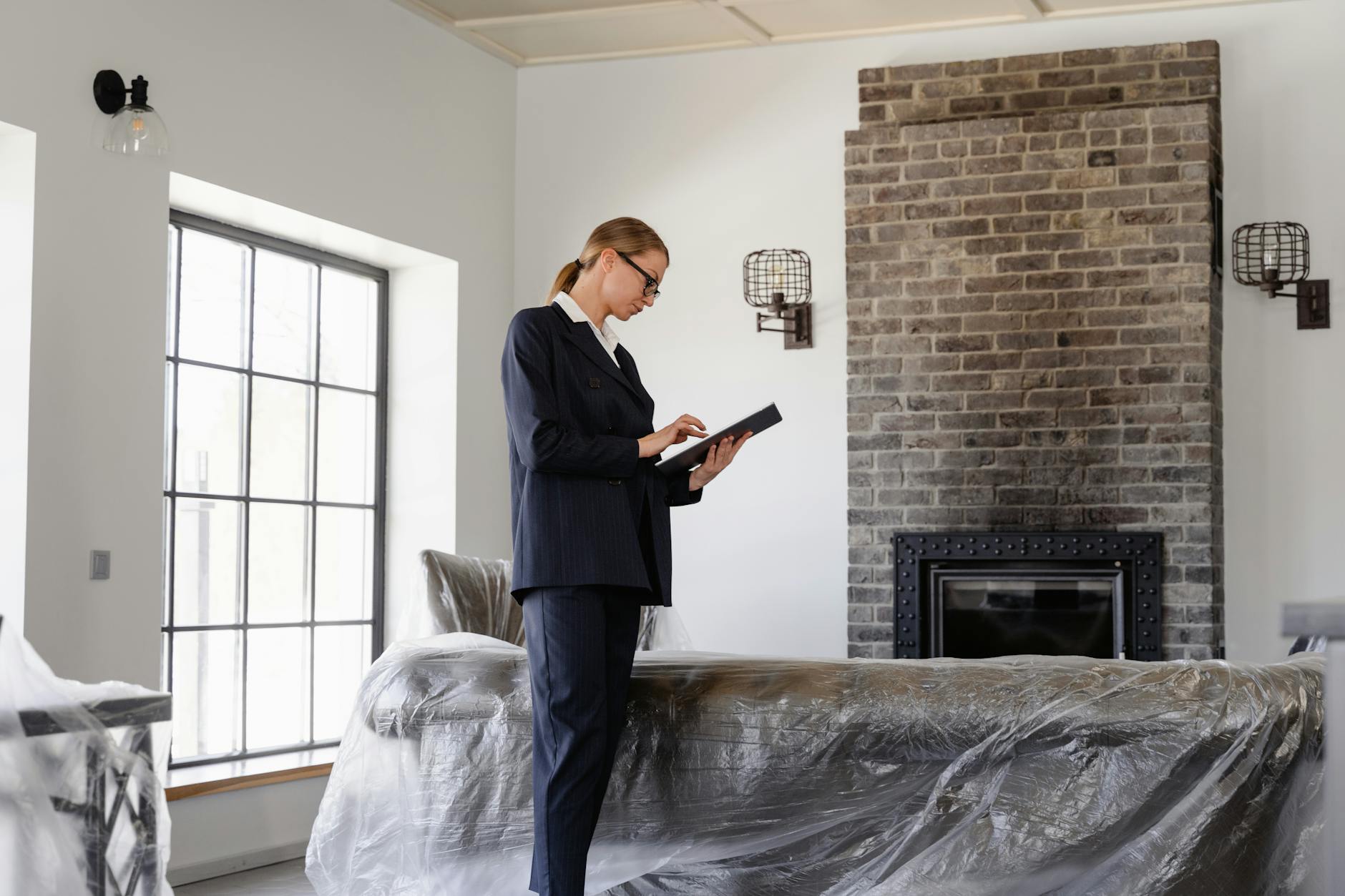 Professional woman inspecting property for real estate purposes with modern interior.
