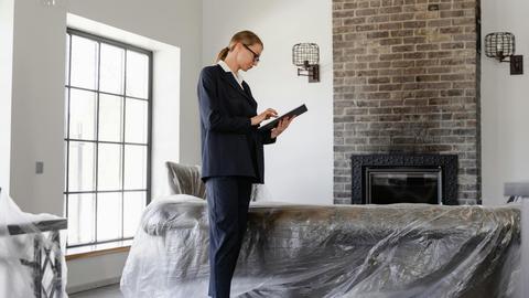 Professional woman inspecting property for real estate purposes with modern interior.
