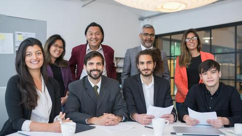 A multicultural business team collaborating in a modern office meeting room.