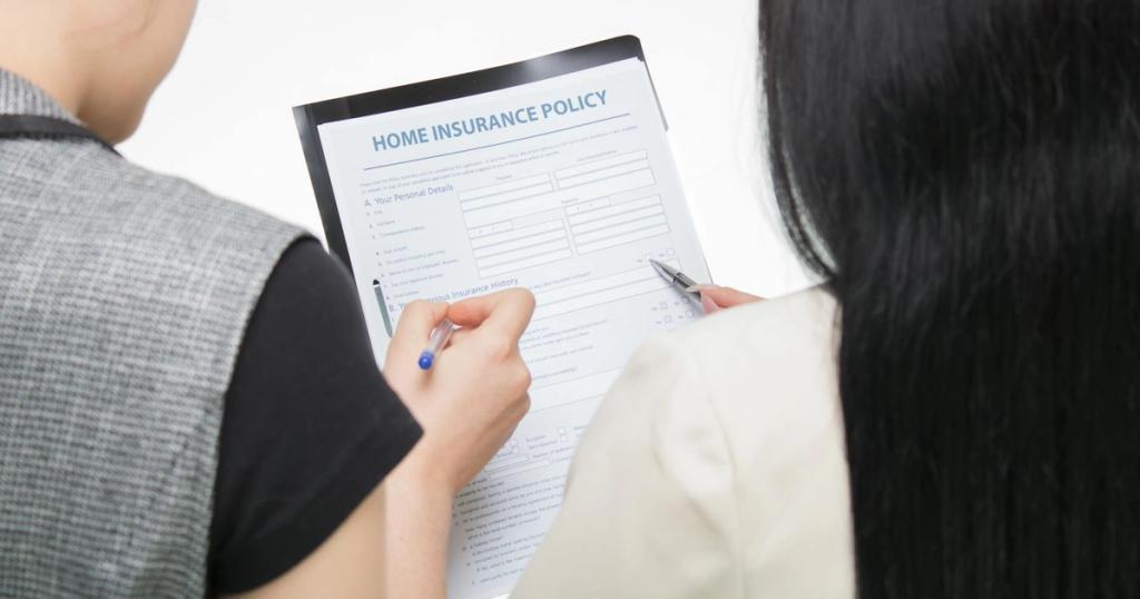 Two women examining home insurance policy form, focused on details.