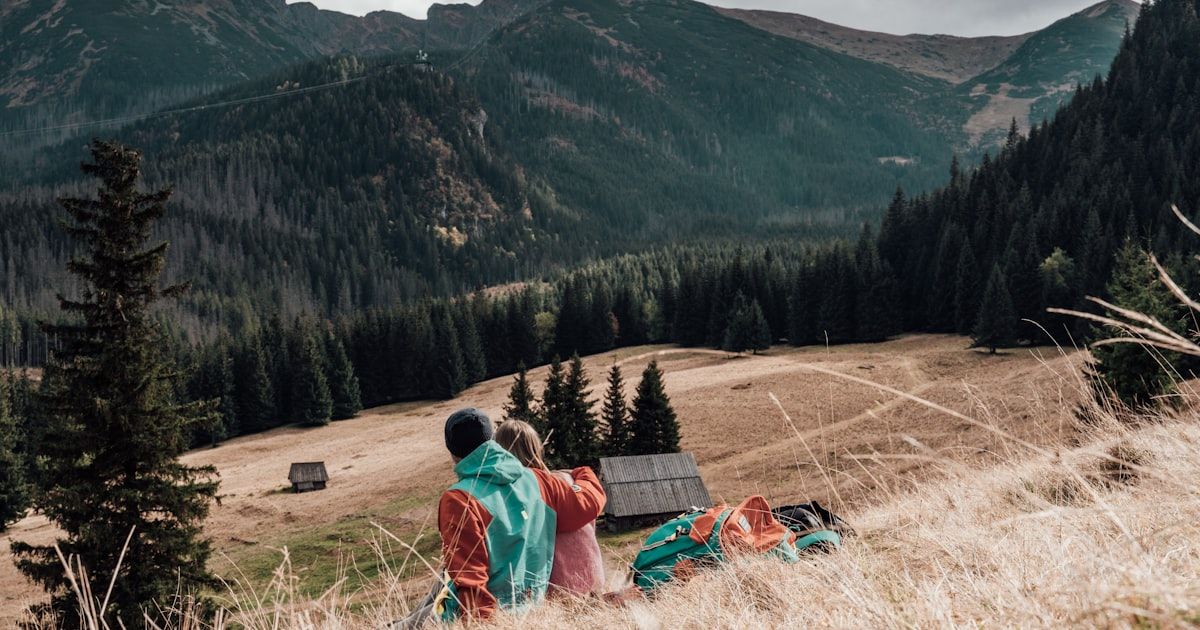 a couple of people that are standing in the grass