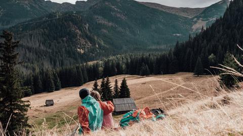 a couple of people that are standing in the grass
