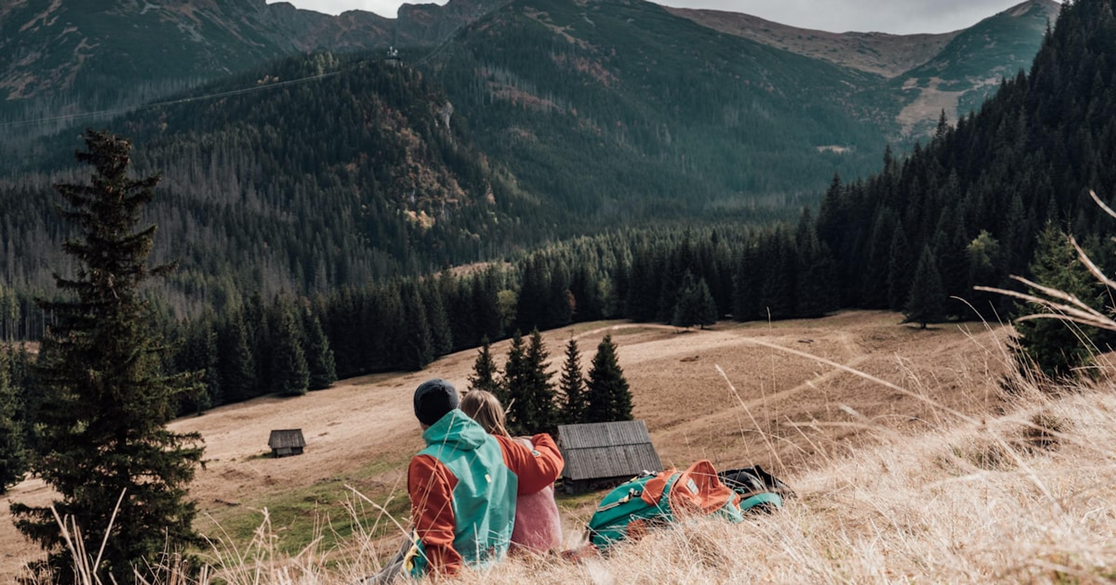 a couple of people that are standing in the grass