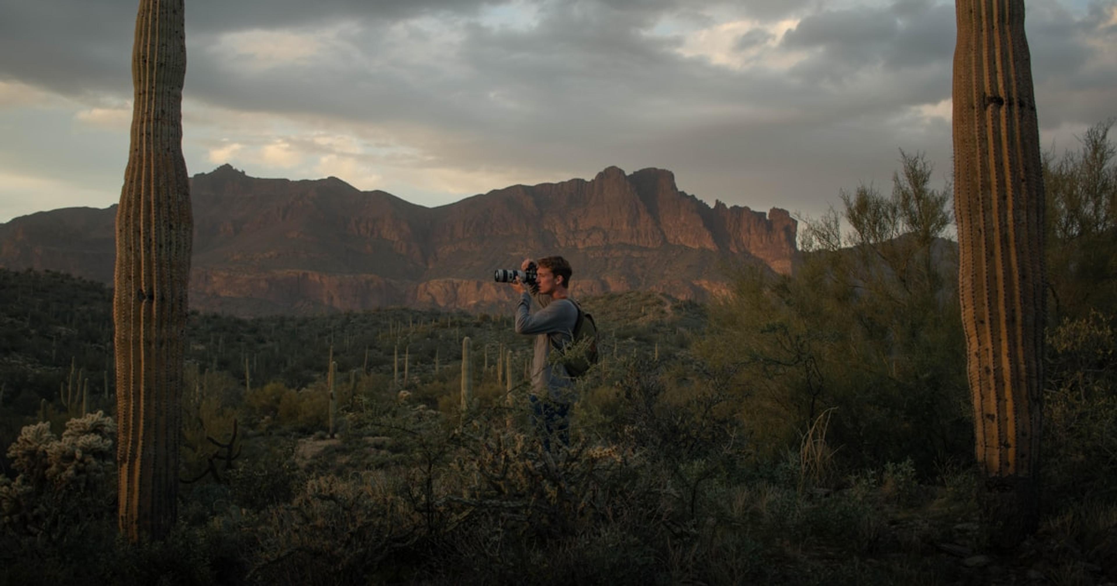 man and woman standing on green grass field during daytime
