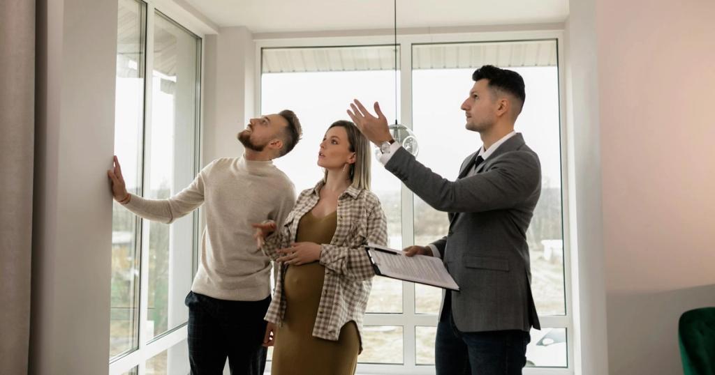A young couple inspects a modern apartment with a real estate agent during a daytime viewing.