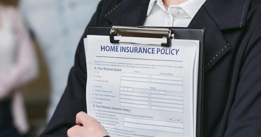 Close-up of a person holding a home insurance policy on a clipboard, captured indoors.