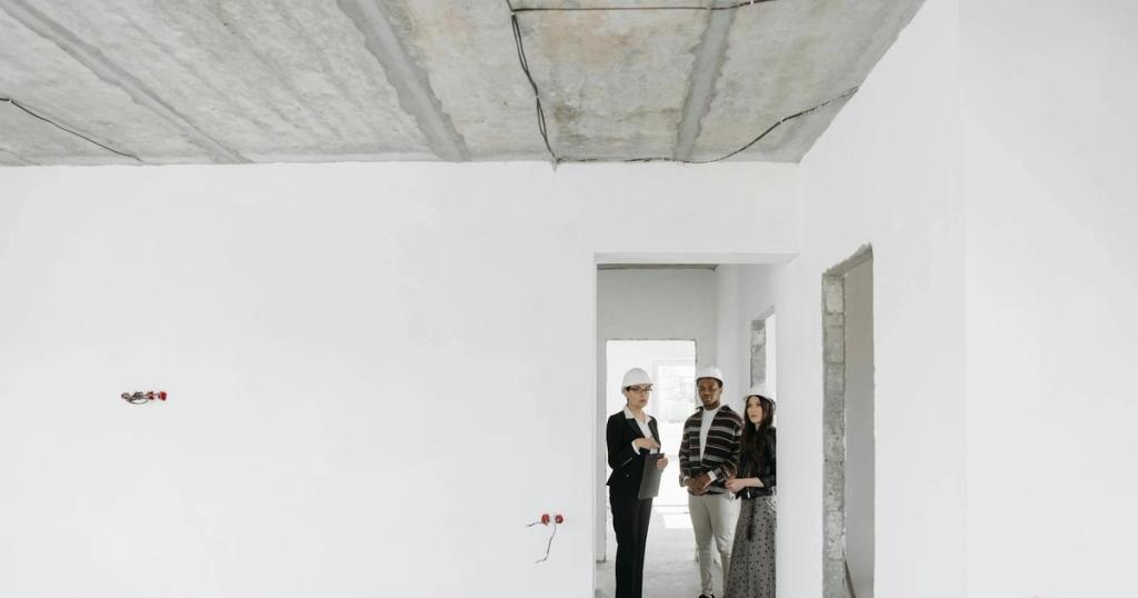 Group of diverse professionals discussing building plans on site.