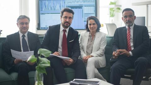 Professional team in corporate attire ready for a meeting, engaged in discussion.