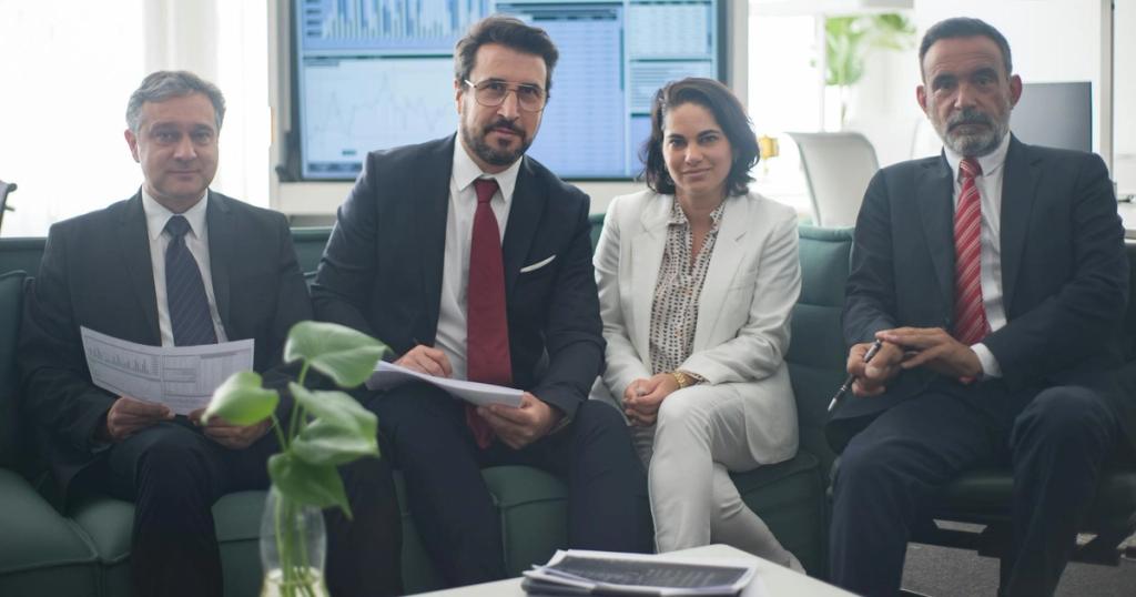 Professional team in corporate attire ready for a meeting, engaged in discussion.