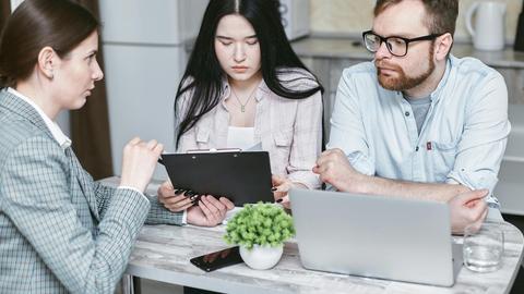 A group of professionals discussing business strategies at a table indoors.