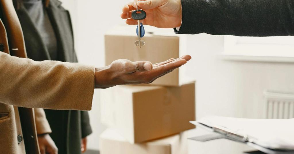 A new homeowner receives keys inside their new home, symbolizing a fresh start.