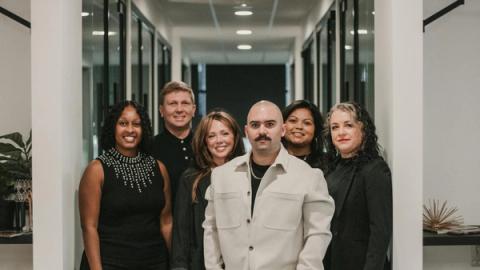 Business professionals posing in a modern office setting in Greenville, South Carolina.