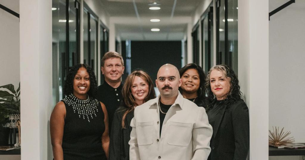 Business professionals posing in a modern office setting in Greenville, South Carolina.
