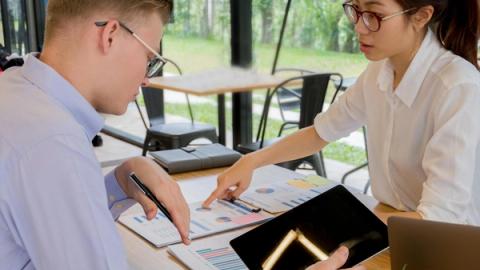 Team collaboration over financial documents in a modern office setting.