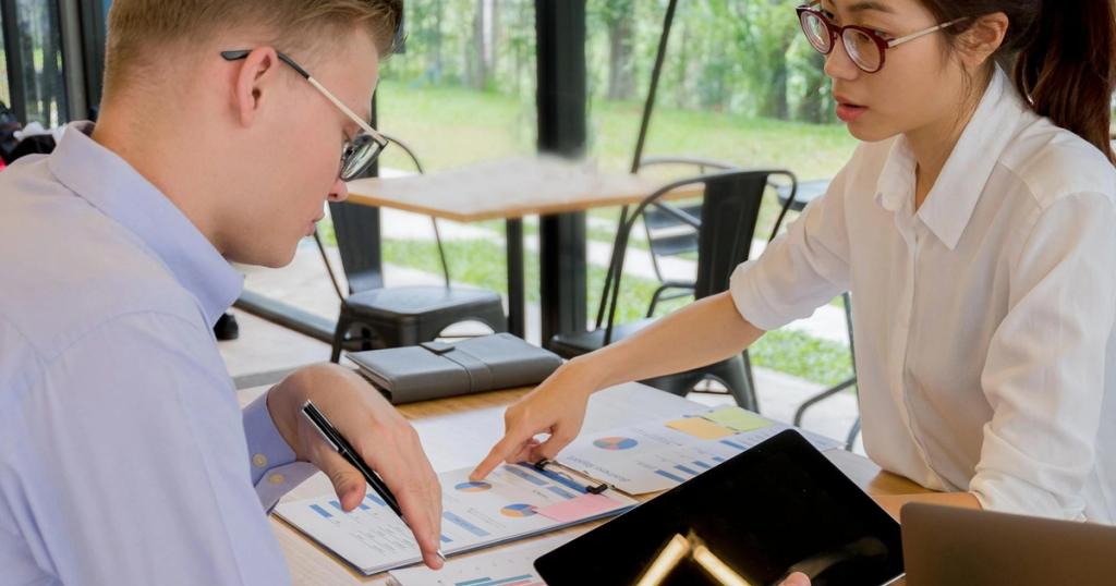 Team collaboration over financial documents in a modern office setting.