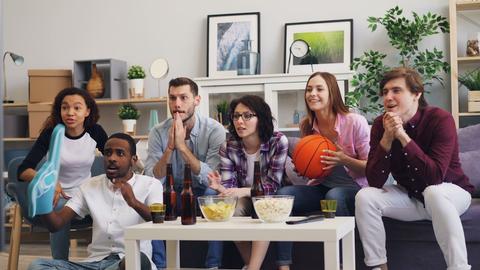 a group of people sitting on a couch in a living room