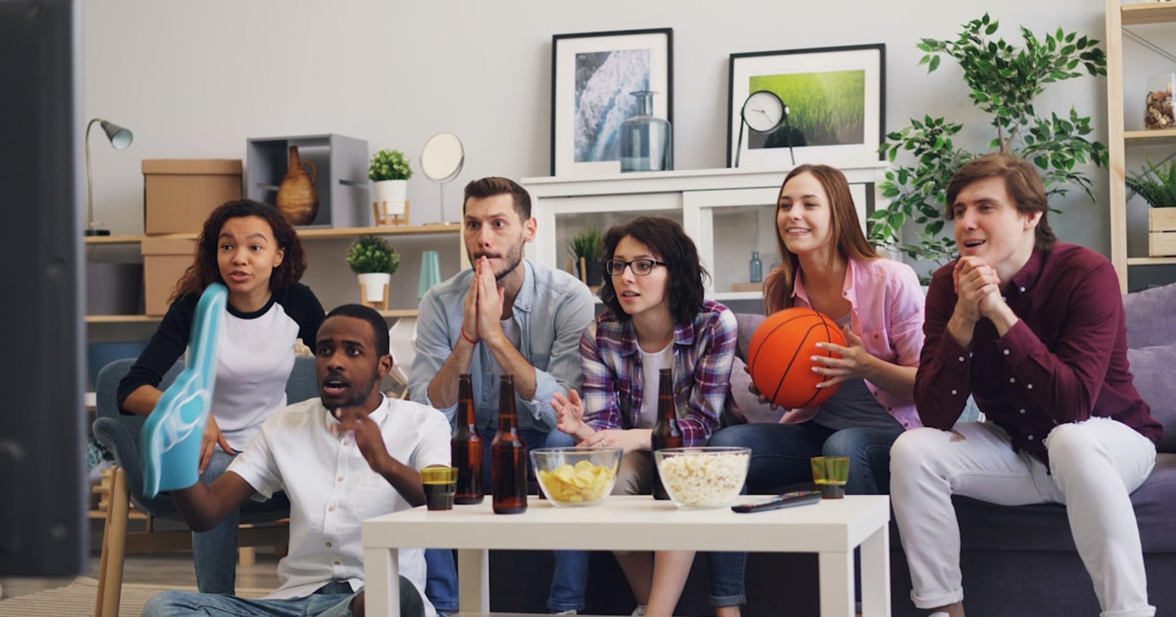a group of people sitting on a couch in a living room