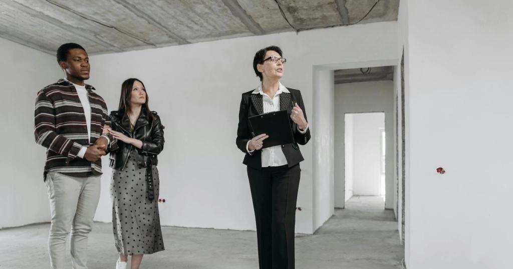 A real estate agent shows an unfinished apartment to prospective buyers.