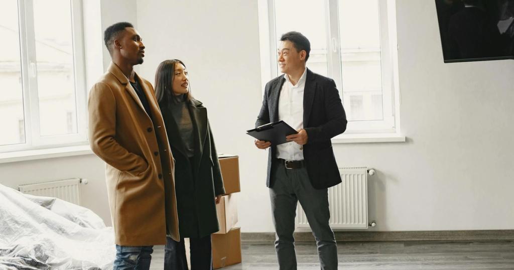 Real estate agent discussing property details with a couple in a modern room.