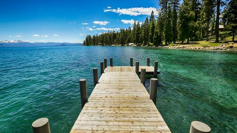 brown wooden dock on blue sea under blue sky during daytime