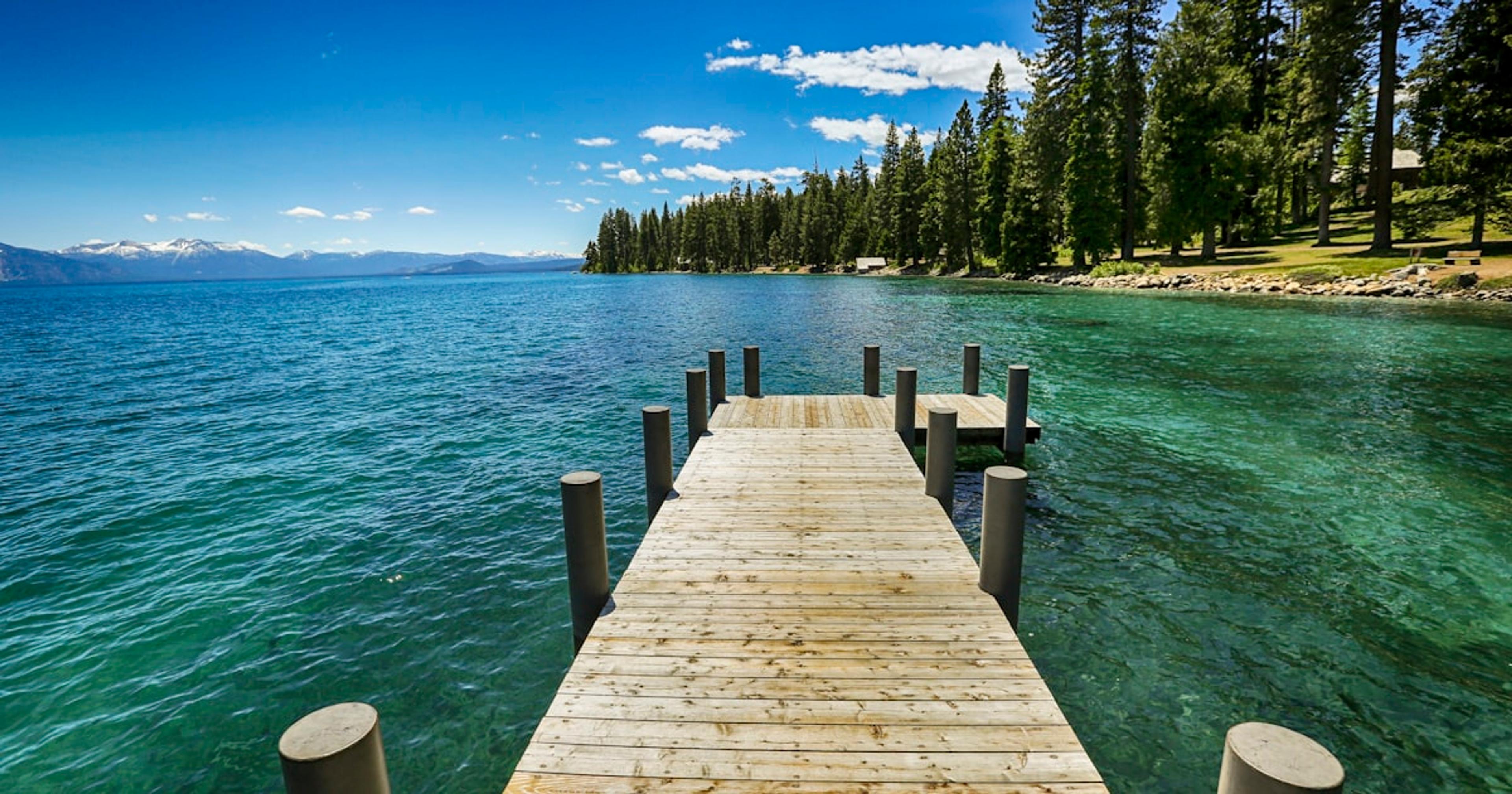 brown wooden dock on blue sea under blue sky during daytime